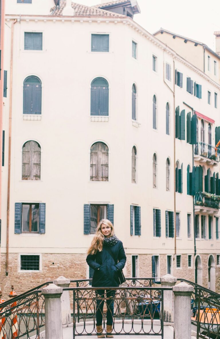 Fashion creator in a stylish jacket on a city bridge